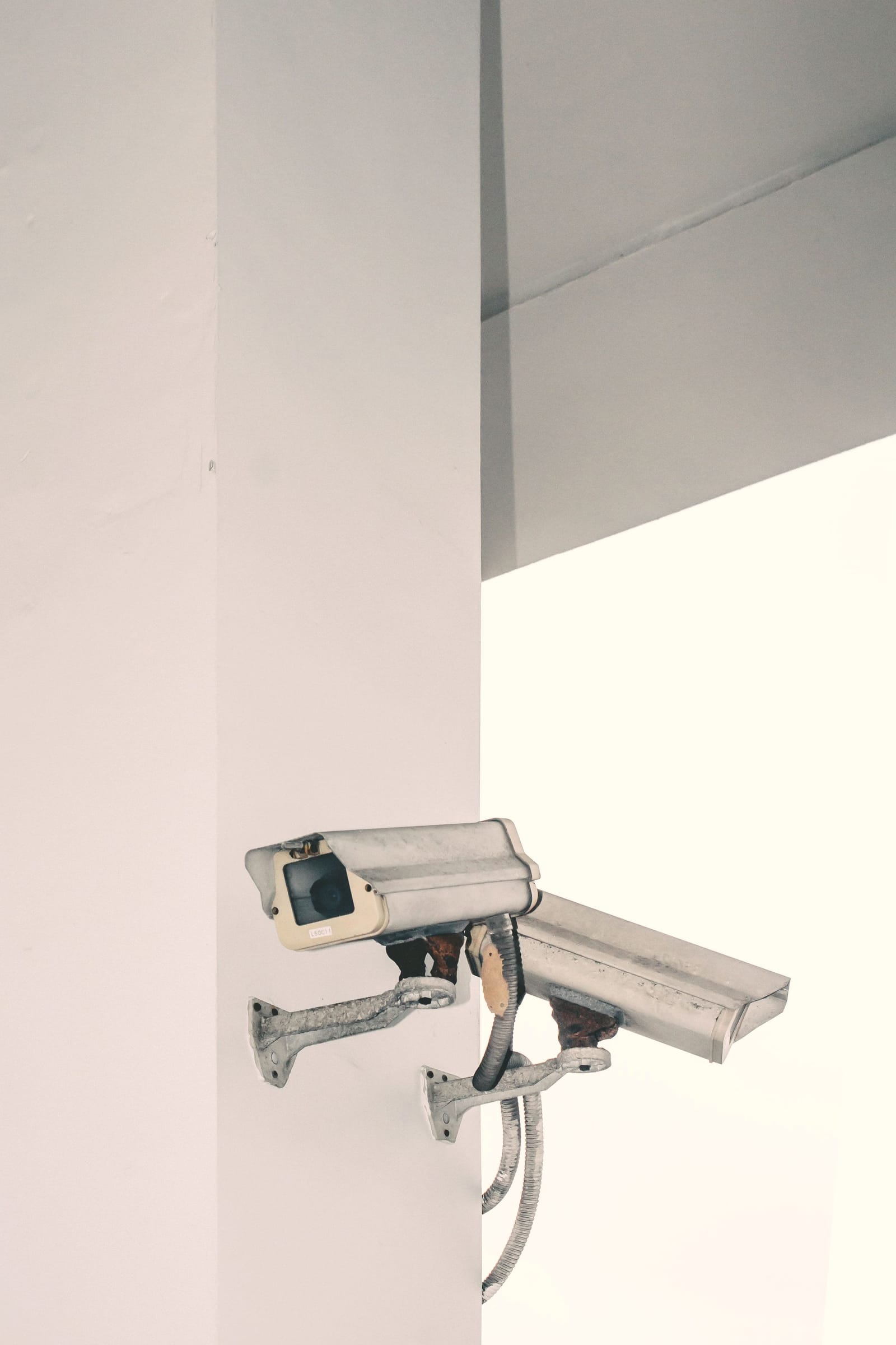 Two security cameras mounted on a wall
