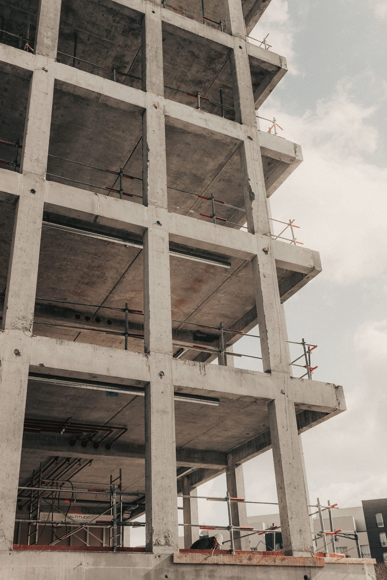 Concrete building frame under construction against the sky