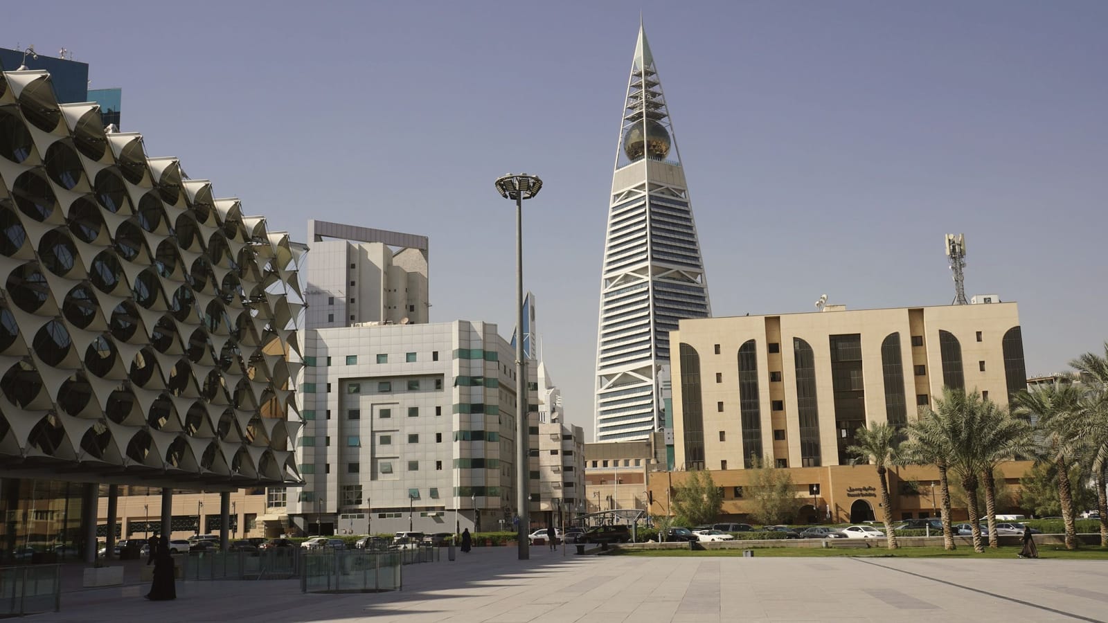 King Fahad National Library facade and Al Faisaliah Tower in Riyadh under a clear sky